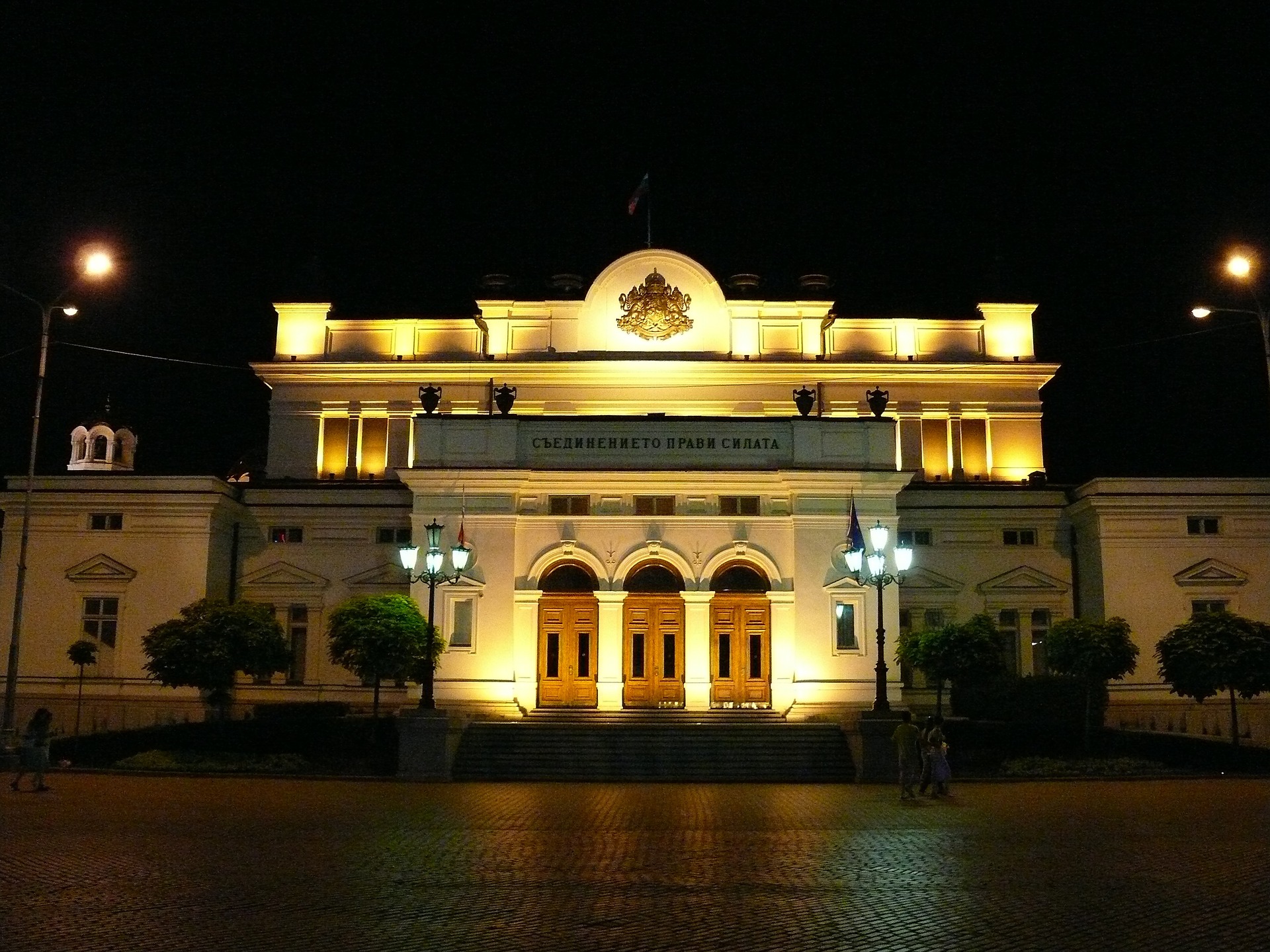 Illuminated neoclassical building in Sofia at night
